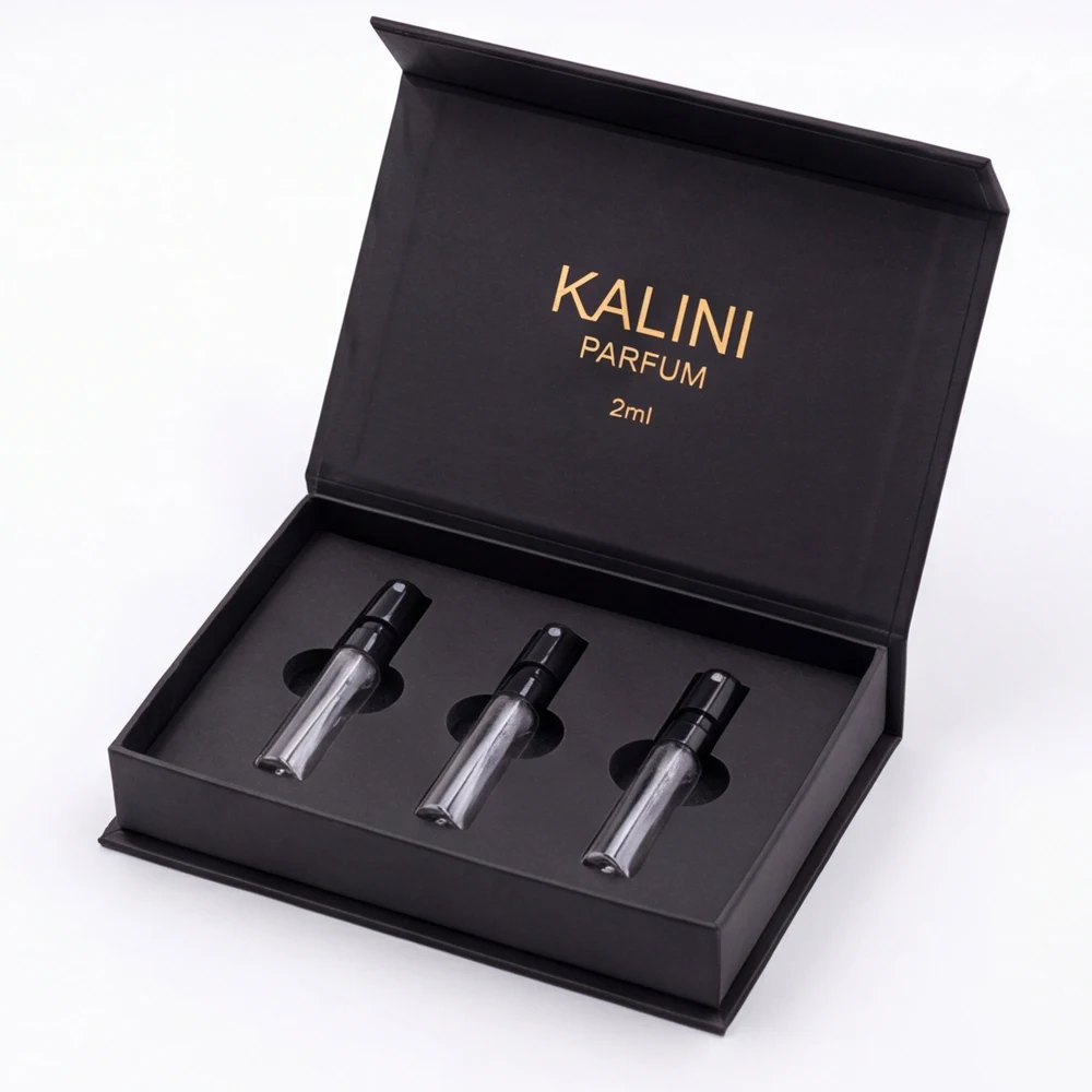 Three perfume sample vials arranged in a fitted hinged discovery-set presentation box